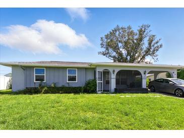 Charming single story home with a well-manicured lawn and covered parking at 6196 Mayberry Ave, North Port, FL 34287