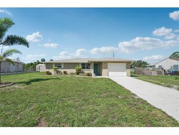 Charming one-story home featuring a well-manicured lawn and an attached garage, creating a welcoming curb appeal at 1107 Seneca Rd, Venice, FL 34293