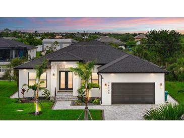 Beautiful single-story home with meticulously maintained landscaping, inviting entrance, and a two-car garage at 14166 Fort Worth Cir, Port Charlotte, FL 33981