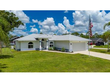 Charming single Gathering home with manicured lawn and attached two car garage at 1865 Rival Ter, North Port, FL 34286