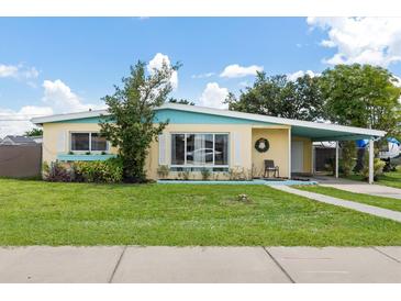 Charming home with a well-maintained front yard, inviting entrance and a carport at 22341 Midway Blvd, Port Charlotte, FL 33952