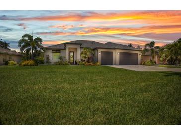 Beautiful single-story home featuring a well-manicured lawn, neutral tones, and a spacious three-car garage at 25062 Palisade Rd, Punta Gorda, FL 33983