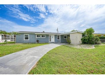 Charming single-story home featuring a well-manicured lawn and a long driveway at 21524 Edgewater Dr, Port Charlotte, FL 33952