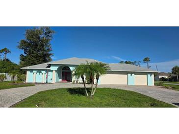 Charming, light blue single-story home with manicured lawn and paver driveway for curb appeal at 39 Norman St, Port Charlotte, FL 33954