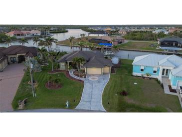Waterfront home with landscaped yard, private dock, boat lift and decorative driveway at 8178 Arlewood Cir, Port Charlotte, FL 33981