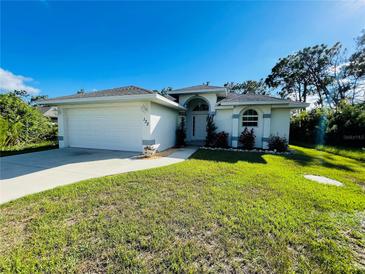 Single-story home with attached garage and landscaped lawn at 133 Wahoo Dr, Rotonda West, FL 33947