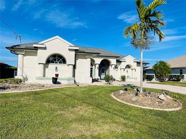 House exterior featuring a well-maintained lawn and landscaping at 8 Sportsman Ter, Rotonda West, FL 33947