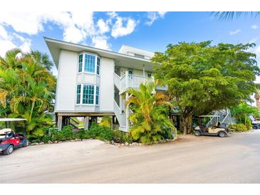 Two-story building with balconies and golf carts at 7454 Palm Island Dr # 3313, Placida, FL 33946