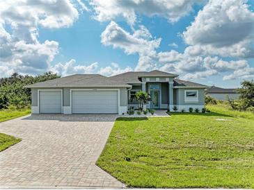 Single-Gathering home with three car garage and paver driveway at 14999 Wichita Rd, Port Charlotte, FL 33981
