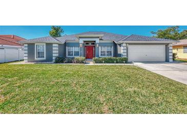 Single-story home with gray exterior and red door at 2341 Rio De Janeiro Ave, Punta Gorda, FL 33983