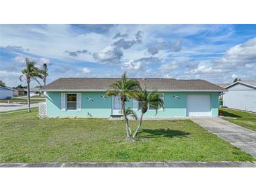Light teal single story home with a two car garage at 13478 Santa Rosa Ave, Port Charlotte, FL 33981