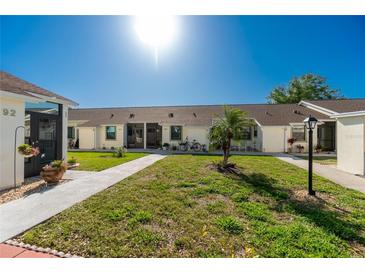 Two-unit building with landscaping and walkways at 6796 Gasparilla Pines Blvd # 95, Englewood, FL 34224