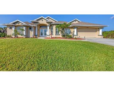 Beautiful two-story home with a large yard, manicured lawn, and attached garage at 14091 Peekskill Ave, Port Charlotte, FL 33981
