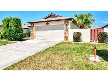 Single-story home with attached garage and landscaped yard at 570 Foxwood Blvd # 196, Englewood, FL 34223