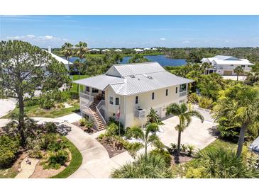 Charming home with metal roof, landscaped yard, and spacious driveway at 13074 Via Flavia, Placida, FL 33946