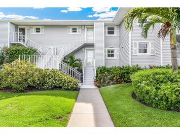 Exterior of light gray building with stairs and landscaping at 5852 Gasparilla Rd # Mv13, Boca Grande, FL 33921