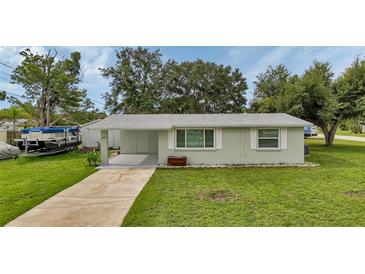 Newly renovated single-story home with a carport and a well-maintained lawn at 2051 Mississippi Ave, Englewood, FL 34224