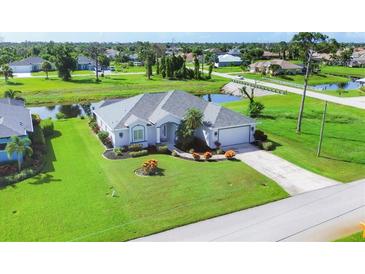 Single-Gathering home with a large backyard, located on a canal at 39 Medalist Cir, Rotonda West, FL 33947