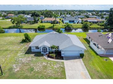 An aerial view of a single-story house with a large yard at 189 Bunker Rd, Rotonda West, FL 33947