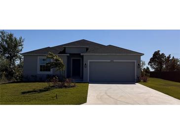 Charming single-story home features a well-maintained lawn and a spacious two-car garage and modern design at 13151 Marathon Blvd, Port Charlotte, FL 33981