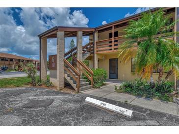 Exterior view of building with stairs and landscaping at 6 Quails Run Blvd # 7, Englewood, FL 34223