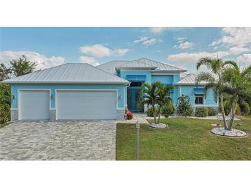 Stunning light blue home with a metal roof and spacious driveway at 10136 Amy Ter, Port Charlotte, FL 33981