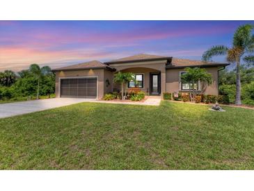 One-story house with a screened patio and lush lawn at 191 Brig W Cir, Placida, FL 33946