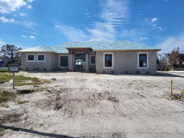 Newly constructed home with block exterior and tile roof at 2614 Oberon Rd, Englewood, FL 34224