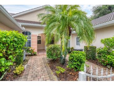 Inviting front patio with lush landscaping and brick walkway at 2024 Lynx Run, North Port, FL 34288