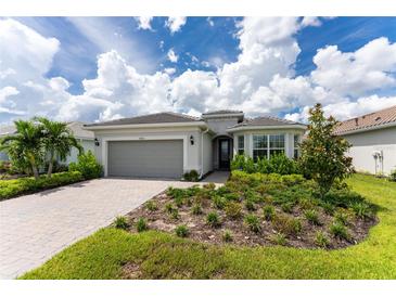 Beautiful house with a landscaped yard and paved driveway at 9982 Beachwalk Dr, Englewood, FL 34223