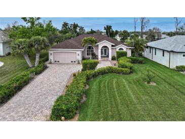 Single-Gathering home with a brick driveway and lush lawn at 229 Rotonda E Blvd, Rotonda West, FL 33947