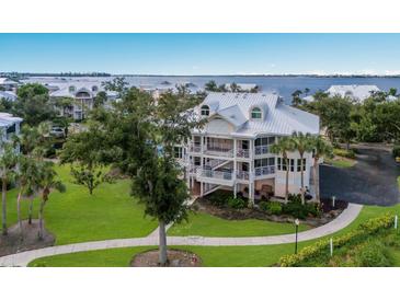 Charming multi-story home with lush landscaping, screened balconies and a metal roof near the water at 11000 Placida Rd # 2303, Placida, FL 33946
