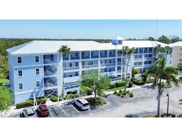 Light blue condo building, three stories high with parking at 8413 Placida Rd # 407, Placida, FL 33946
