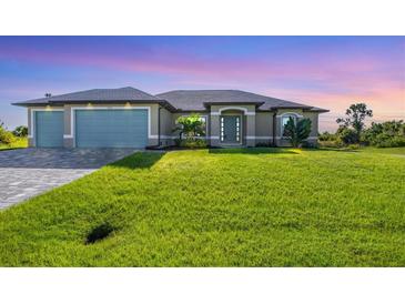 Two-car garage and well-manicured lawn at 8374 Agate St, Port Charlotte, FL 33981