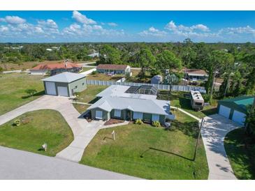 Aerial view of a single-Gathering home with detached garage, pool, and RV parking at 7168 Lighthouse St, Englewood, FL 34224