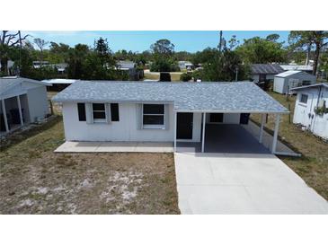 Charming single-story home featuring a new roof, covered carport, and freshly painted exterior at 317 E Green St, Englewood, FL 34223