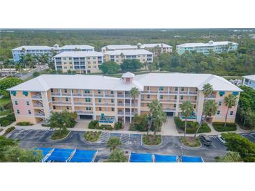 Aerial view of a condo building with parking and landscaping at 8403 Placida Rd # 303, Placida, FL 33946