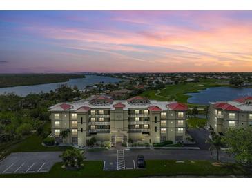 Stunning waterfront condo building with red tile roof overlooking the golf course and ocean at 10055 Links Ln # 206, Rotonda West, FL 33947