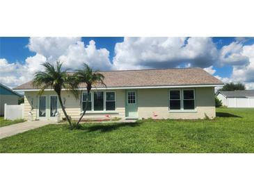 One-story home with light-colored brick and landscaping at 13528 Martha Ave, Port Charlotte, FL 33981