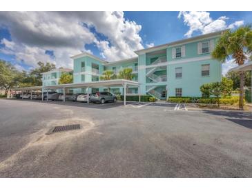 Condo building with covered parking and landscaping at 19385 Water Oak Dr # L-106, Port Charlotte, FL 33948