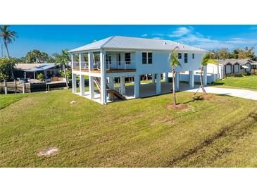 Elevated home on stilts with a large yard and canal views at 4199 Hollis Ave, Port Charlotte, FL 33953