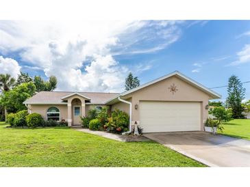 Single-story home with a two-car garage at 13511 Foresman Blvd, Port Charlotte, FL 33981