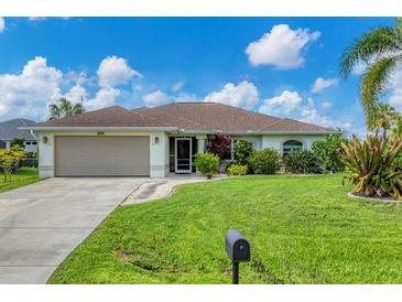 Single-story home with two-car garage and lush lawn at 2555 Dixon Ter, Port Charlotte, FL 33981
