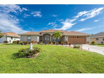 Single story home with landscaped yard and fountain at 240 White Marsh Ln, Rotonda West, FL 33947