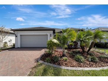 Single-story home with two-car garage and well-manicured landscaping at 1337 Sorrell Way, North Port, FL 34289