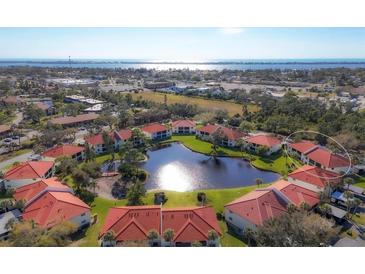 Condo community with lake access and a waterfront view at 514 Pine Hollow Cir # 514, Englewood, FL 34223