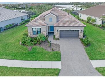 One-story home with tile roof and stone accents at 10985 Trevino St, Englewood, FL 34223