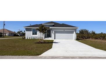 Charming single-story home featuring a well-manicured lawn and an attached two-car garage at 148 Lime Tree Park, Rotonda West, FL 33947
