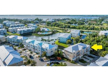Aerial view of waterfront community, highlighting the subject property and resort-style amenities at 10311 Lands End Cir # 13, Placida, FL 33946