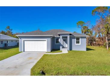Newly built single-story home with gray exterior and white garage at 308 Capatola St, Port Charlotte, FL 33948